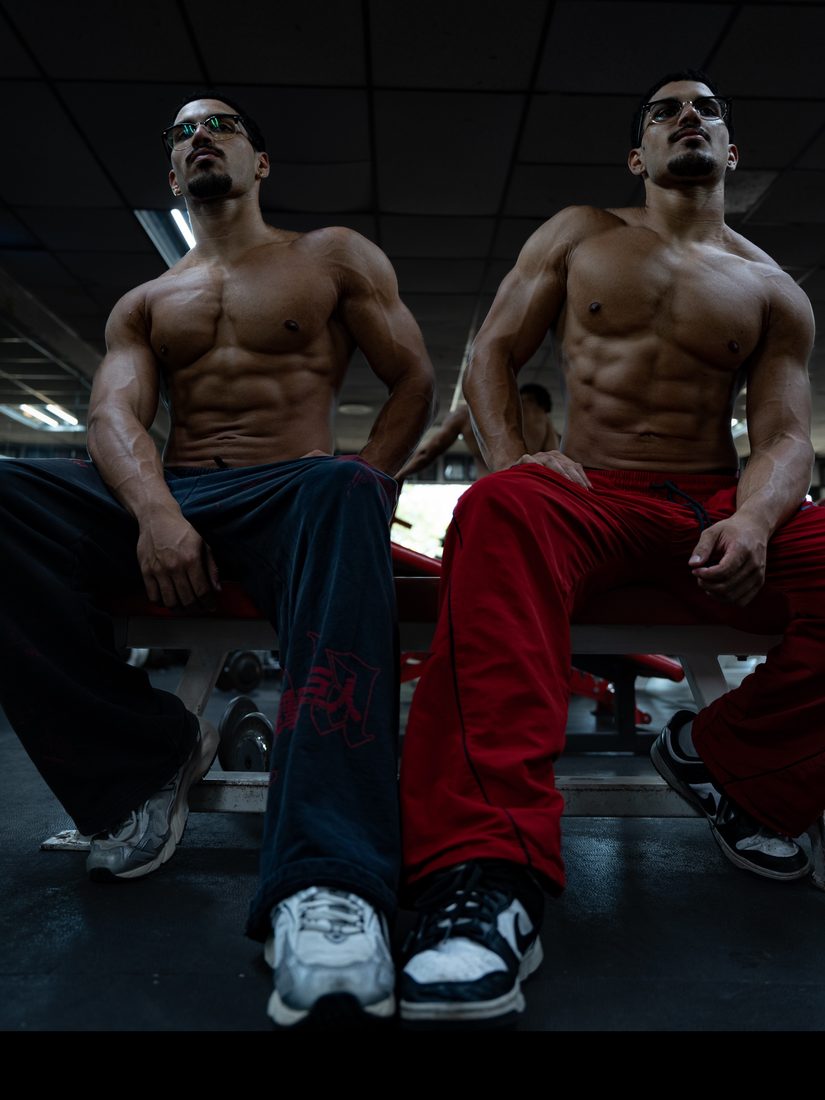 Louis and Anthony seated on a gym bench