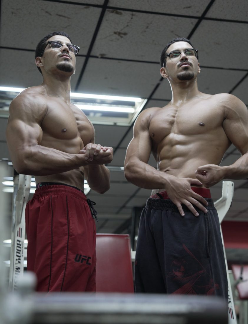Louis and Anthony posing in the gym